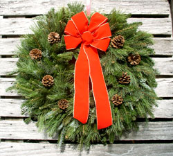 Mixed greens wreath with red ribbon
